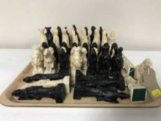 A quantity of resin chess pieces and board