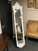 An ornate white framed easel mirror