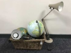 A wicker basket containing two globes and two mid twentieth century angle poise lamps