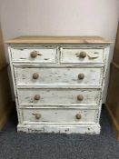 A rustic pine five drawer chest