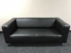 A pair of black leather office style settees