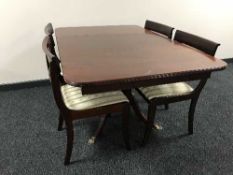 A mahogany Regency style pedestal dining table with three leaves and four chairs