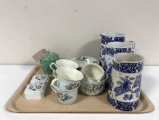 Three antique blue and white graduated jugs and eighteen pieces of Wade tea china,