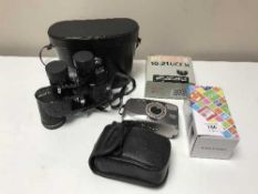 A pair of cased Revue binoculars together with Pentax binoculars,