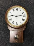 A contemporary walnut circular wall clock with fusee movement