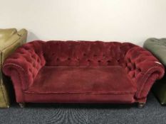 An early twentieth century red buttoned dralon drop end settee