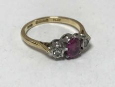 An 18ct gold and platinum set two stone diamond and ruby ring
