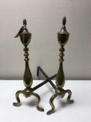 A pair of heavy brass fire dogs
