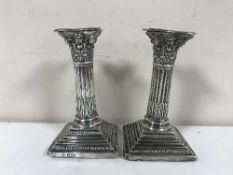 A pair of silver Corinthian column candlesticks,