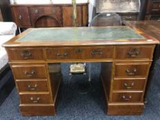 A Yew wood pedestal desk inset with green leather panel