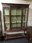 An Edwardian mahogany display cabinet on Queen Ann style legs