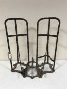 Two antique cast metal saddle brackets together with a small wall bracket (3)