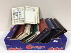 A box of nine assorted albums and folders containing stamps of the world and first day covers