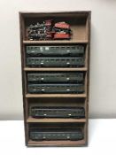 A wooden display case containing two Bachman trains with wagons and six Hornby carriages