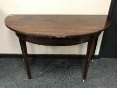 A Victorian mahogany D-shaped table