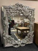 An ornate silvered framed mirror