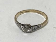 18ct gold solitaire diamond with diamonds to the shoulders - approximately .
