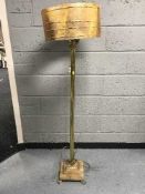 A heavy brass Corinthian column standard lamp with shade