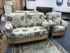An Ercol two seater settee and matching armchair with floral cushions (2)