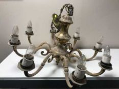 A pair of heavy brass eight branch chandeliers