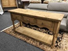 A reclaimed pine kitchen low work table fitted with three drawers
