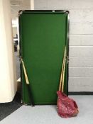 A 6' snooker table with cues and accessories
