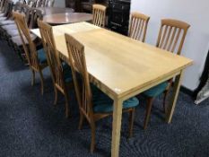 A contemporary oak effect extending table and six Danish Hoffer teak chairs