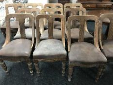 A set of fourteen Victorian oak dining chairs