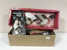 A box of vintage games including Monopoly, Mastermind, chess boards,