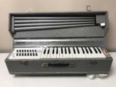 A Busilacchio reed organ together with a box of sheet music