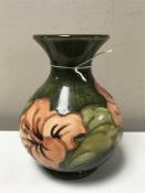 A Moorcroft amaryllis vase on green ground,