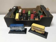 A box containing thirteen great british die cast buses on stands