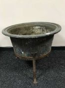 An antique copper planter on cast metal three way stand, width 74 cm.