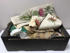 A box of table linen, cushion, fur hats,