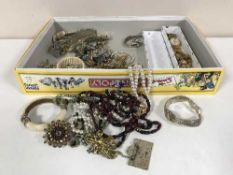 A box of costume jewellery, bangles, brooches,