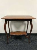 A shaped Edwardian mahogany occasional table
