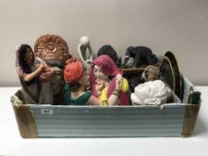 Two boxes of Eastern carved masks, elephant figures, postcards, statues, bookends,