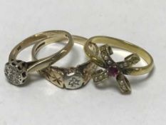 Three gold rings, two set with diamonds,