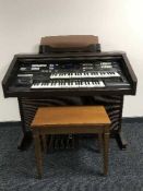 A Technics General Midi GA electric organ and stool plus a quantity of organ books