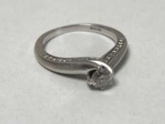 A 9ct white gold diamond solitaire ring, set with diamond shoulders,