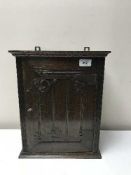 An oak arts and crafts wall cabinet