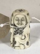 A carved bone Japanese netsuke