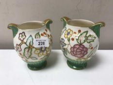 A pair of Crown Devon vase with gilded highlights and light floral design.