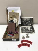 A pine box containing a trio of WWI medals together with four WW II medals,