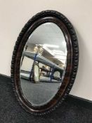 An Edwardian mahogany oval bevelled mirror