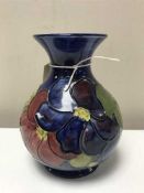 A Moorcroft anemone tubelined vase on blue ground,