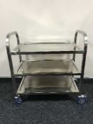A metal three tier catering trolley