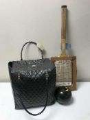 A bag of four bowls together with two golf clubs (drivers) and tennis racket