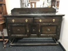 An early 20th century carved oak sideboard