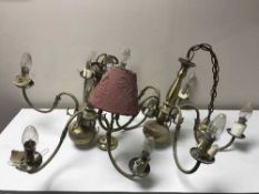 A pair of brass five branch chandeliers